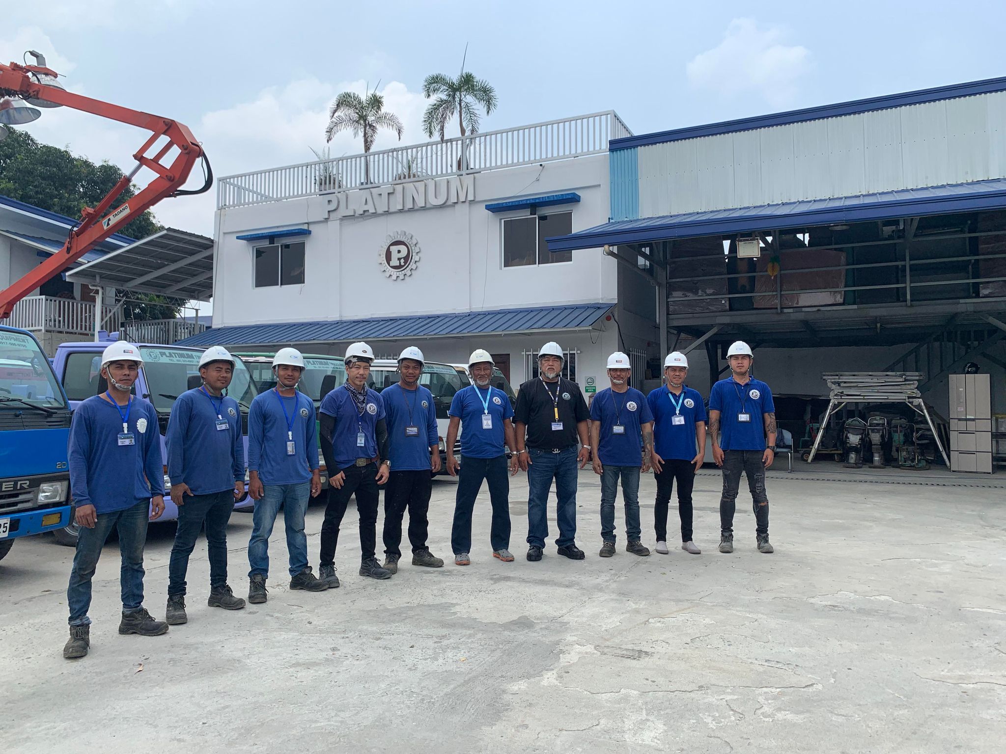 The team outside the Platinum building and fleet